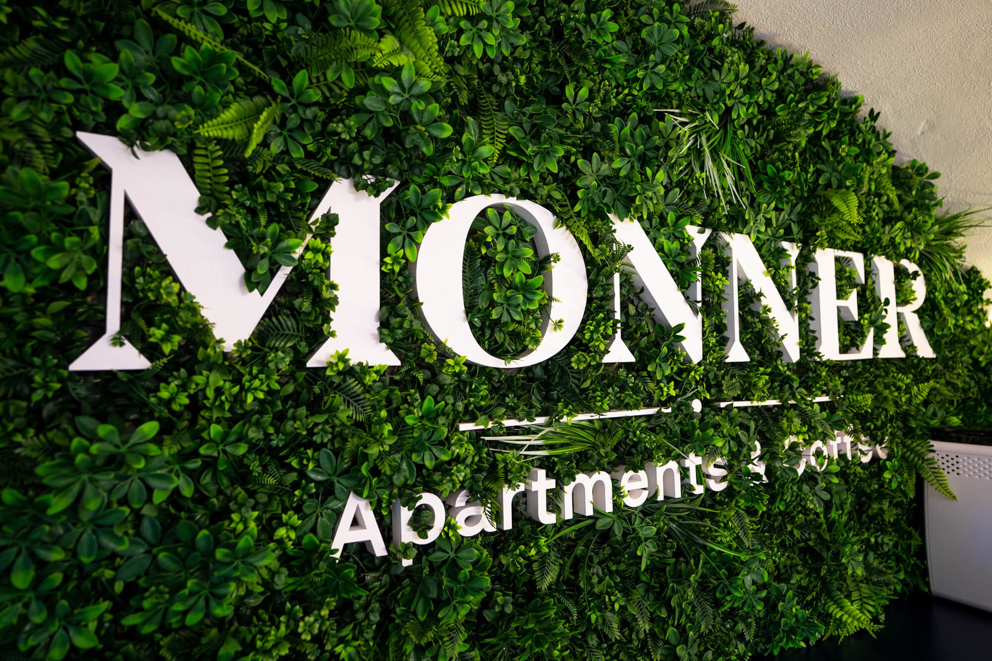 Moss wall with the Monner logo